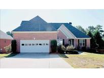 Charming single-story brick home with a two-car garage and beautifully landscaped front yard at 1225 Martin Chapel Ln, Lawrenceville, GA 30045
