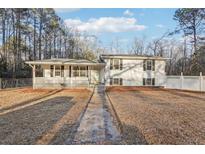 Charming two-story home with a inviting front porch and well-maintained lawn at 2248 Bethel Rd, Conyers, GA 30012