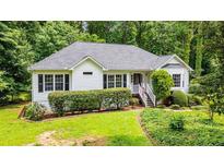 Charming ranch style home with well-maintained landscaping, mature trees, and a welcoming entrance at 567 Leah Drive, Powder Springs, GA 30127