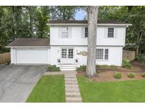 Charming two-story home with a white painted brick exterior, well-maintained landscaping, and an attached two-car garage at 3981 Longview Dr, Chamblee, GA 30341