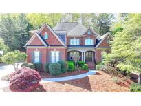 Charming brick home with a well-manicured lawn and inviting front entrance at 10125 Brixton Pl, Suwanee, GA 30024