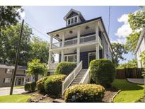 Charming two-story home with a welcoming front porch and manicured landscaping at 1164 Baylor Nw St, Atlanta, GA 30318