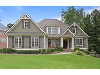 Charming home featuring classic design elements, manicured lawn, and lush landscaping at 414 Wallis Farm Way Way, Marietta, GA 30064