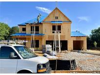 New construction home with blue roof being built in a beautiful neighborhood at 675 Crest Line Trl, Powder Springs, GA 30127