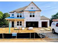 New two-story home under construction with visible framework and materials, showcasing the building process at 675 Crest Line Trl, Powder Springs, GA 30127