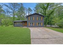 Charming two-story home boasts a beautifully landscaped yard and a freshly sealed driveway at 336 Fond Du Lac Dr, Stone Mountain, GA 30088