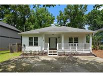 Charming single-story home with a welcoming front porch and manicured landscaping at 1245 Ladd Sw St, Atlanta, GA 30310