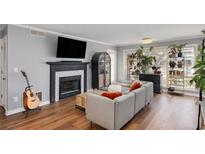Inviting living room features a fireplace, hardwood floors, and abundant natural light perfect for relaxation and entertaining at 303 Gettysburg Pl, Atlanta, GA 30350