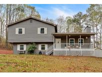 Split level home featuring gray siding, white trim, covered porch, and mature trees at 3640 Silver Leaf Sw Ln, Marietta, GA 30008