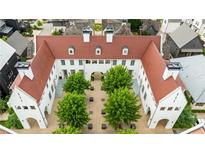 Stunning aerial view showcasing a residential building with a central courtyard featuring lush greenery and hardscape at 11277 Serenbe Ln, Chattahoochee Hills, GA 30268