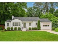 Charming single-story home with a well-manicured lawn and beautiful landscaping at 1383 Fenway Cir, Decatur, GA 30030