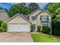 Charming two-story home featuring a two-car garage and well-maintained front yard, perfect for Gathering living at 3732 Landgraf Cv, Decatur, GA 30034