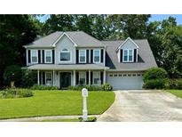 Charming two-story home with a well-manicured lawn and a welcoming front porch at 25 Jessamine Trail Trl, Lawrenceville, GA 30046