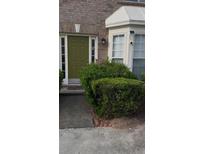Charming home entrance with an olive colored front door and well maintained landscaping at 2735 Parkway Trl, Lithonia, GA 30058