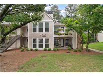 Charming condo with a stone chimney and a welcoming front yard at 3408 Lake Pointe Cir, Roswell, GA 30075