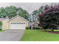Charming single-Gathering home featuring an attached garage and well-maintained front lawn at 1115 Hunters Creek Ct, Lawrenceville, GA 30043