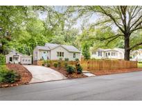 Charming home featuring a well-maintained front yard, a cute picket fence, and a lovely curb appeal at 1583 Braeburn Se Dr, Atlanta, GA 30316