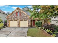 Charming stone home with a two-car garage, covered porch, and beautiful landscaping at 123 Patrick Way, Marietta, GA 30064