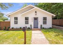 Charming single-story home featuring a well-manicured lawn and inviting front porch entrance at 2294 Hill Nw St, Atlanta, GA 30318