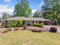 Charming single-story home with brick facade, manicured landscaping, and a lush green lawn at 755 Monticello Se Way, Marietta, GA 30067