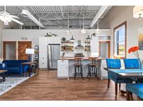 Open kitchen features stainless steel appliances, white cabinetry, and a butcher block island with seating at 5097 Peachtree Rd # I, Atlanta, GA 30341