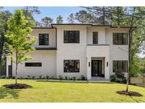 Striking modern home featuring a manicured lawn, elegant landscaping, and a sleek contemporary design at 3293 Lenox Ne Pl, Atlanta, GA 30324