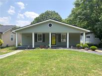 Charming single-story home featuring a well-manicured lawn and a covered porch with decorative columns at 644 Albert Nw St, Atlanta, GA 30318