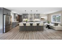 Bright, open kitchen with stainless steel appliances, a large island with seating, and gray cabinets and island at 1120 Taliwa Ne Trl, Marietta, GA 30068
