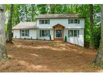 Charming two-story home with a brick exterior, complemented by a welcoming front porch and well-manicured landscaping at 280 E Valley Dr, Marietta, GA 30068
