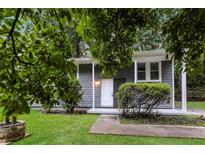 Charming single-story home with gray siding, white trim, and a well-manicured lawn at 6480 Port A Prince Drive Dr, Forest Park, GA 30297