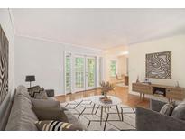 Comfortable living room with hardwood floors, neutral colors, and access to the outdoors at 1445 Monroe Ne Dr # F10, Atlanta, GA 30324