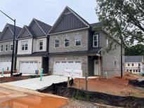 Modern townhomes feature brick exteriors, attached garages, and well-lit driveways at 3102 Marbella Cir # 1, Kennesaw, GA 30152