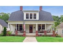 Charming two-story home with white siding, inviting front porch, and well-maintained lawn at 27 Sessions Nw St, Marietta, GA 30060