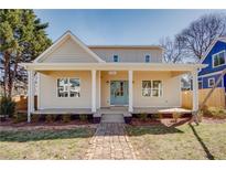 Charming home featuring a quaint brick walkway leading to a covered front porch with a light blue front door at 3286 Bachelor Street, East Point, GA 30344