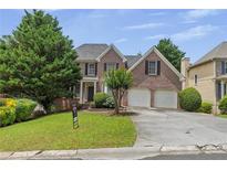 Charming brick two-story home with a two car garage and mature landscaping at 4815 Rapids Nw Cir, Acworth, GA 30102