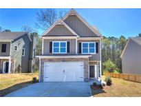 Charming two-story home featuring a stone-accented garage and a well-manicured front lawn, perfect for curb appeal at 335 Melody Ne Ln, Cartersville, GA 30121