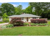 Charming single-story home featuring a well-manicured lawn and beautiful landscaping at 3349 Concord Se Cir, Smyrna, GA 30080