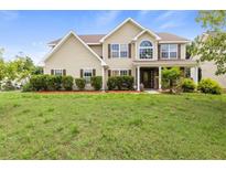 Charming two-story home with landscaped yard and inviting front porch at 3385 Amhurst Pkwy, Atlanta, GA 30349