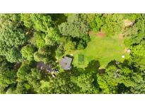 An aerial view showcases the property with a home, surrounded by lush greenery and a well-maintained yard at 12728 Bells Ferry Rd, Canton, GA 30114