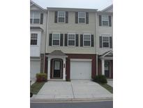 Two-story townhome with brick accents, a front-entry garage and black shutters for a clean, modern look at 6895 Slate Stone Se Way # 3, Mableton, GA 30126