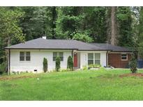 Charming one-story home with a brick facade, neat landscaping, and a well-maintained green lawn at 3175 West Manor Sw Cir, Atlanta, GA 30311