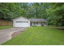 Charming single-story home featuring a manicured lawn and an attached two-car garage at 10073 Dorothy Ct, Jonesboro, GA 30236