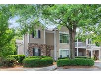 Charming condo featuring stone accents, neutral siding, a cozy balcony and lush landscaping at 2400 Cumberland Se Pkwy # 613, Atlanta, GA 30339