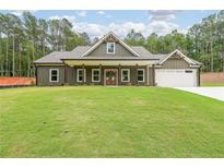 Inviting single-Gathering home with a well-manicured lawn and a charming covered front porch at 96 Lexie Ct, Rockmart, GA 30153