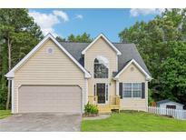 Charming traditional home with a two-car garage and well-manicured lawn at 1039 Megan Ct, Sugar Hill, GA 30518