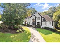 Elegant two-story home with a well-manicured lawn and circular driveway at 4670 Hamden Forest Sw Dr, Atlanta, GA 30331
