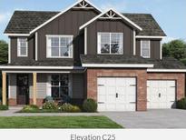 Charming two-story home with a brick and gray facade, complemented by a well-manicured lawn and a two-car garage at 214 Villa Rica Spgs, Villa Rica, GA 30180