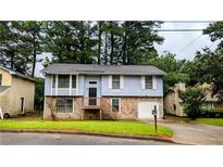 Charming two-story home with stone accents and a welcoming front porch, surrounded by mature trees at 2168 Sara Ashley Way, Lithonia, GA 30058