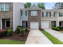 Charming townhome with brick facade, garage, well-maintained landscaping, and inviting curb appeal at 3155 Tarian Way, Decatur, GA 30034