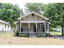 Charming single-story home with a welcoming front porch and well-manicured lawn at 8316 Grady St, Douglasville, GA 30134